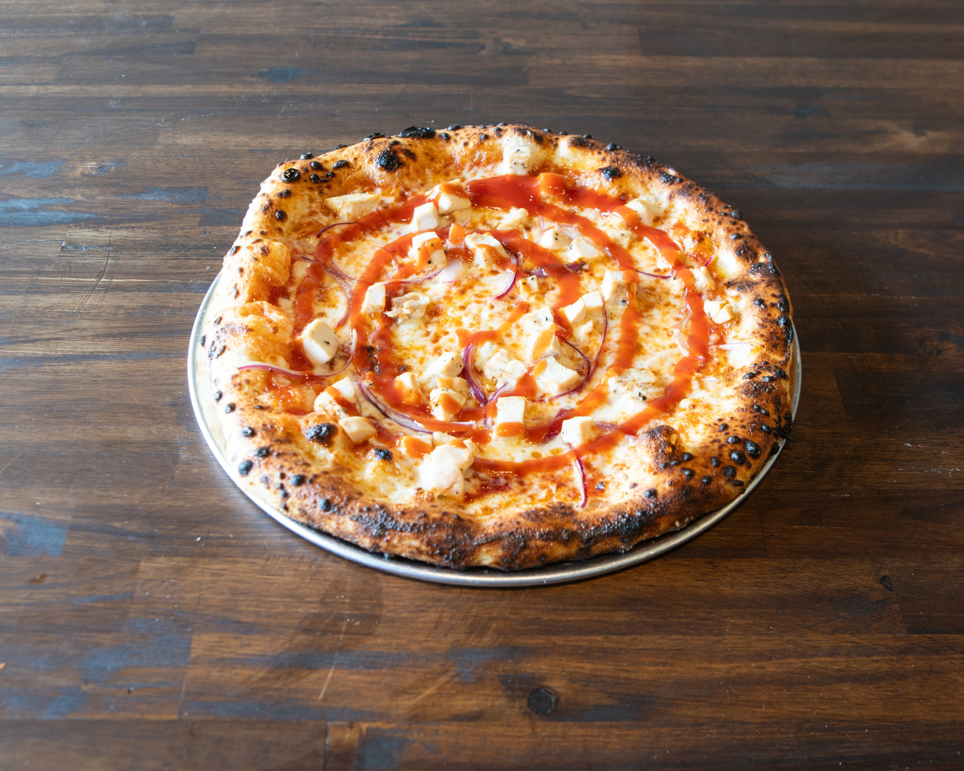 BBQ chicken pizza with pickled red onion